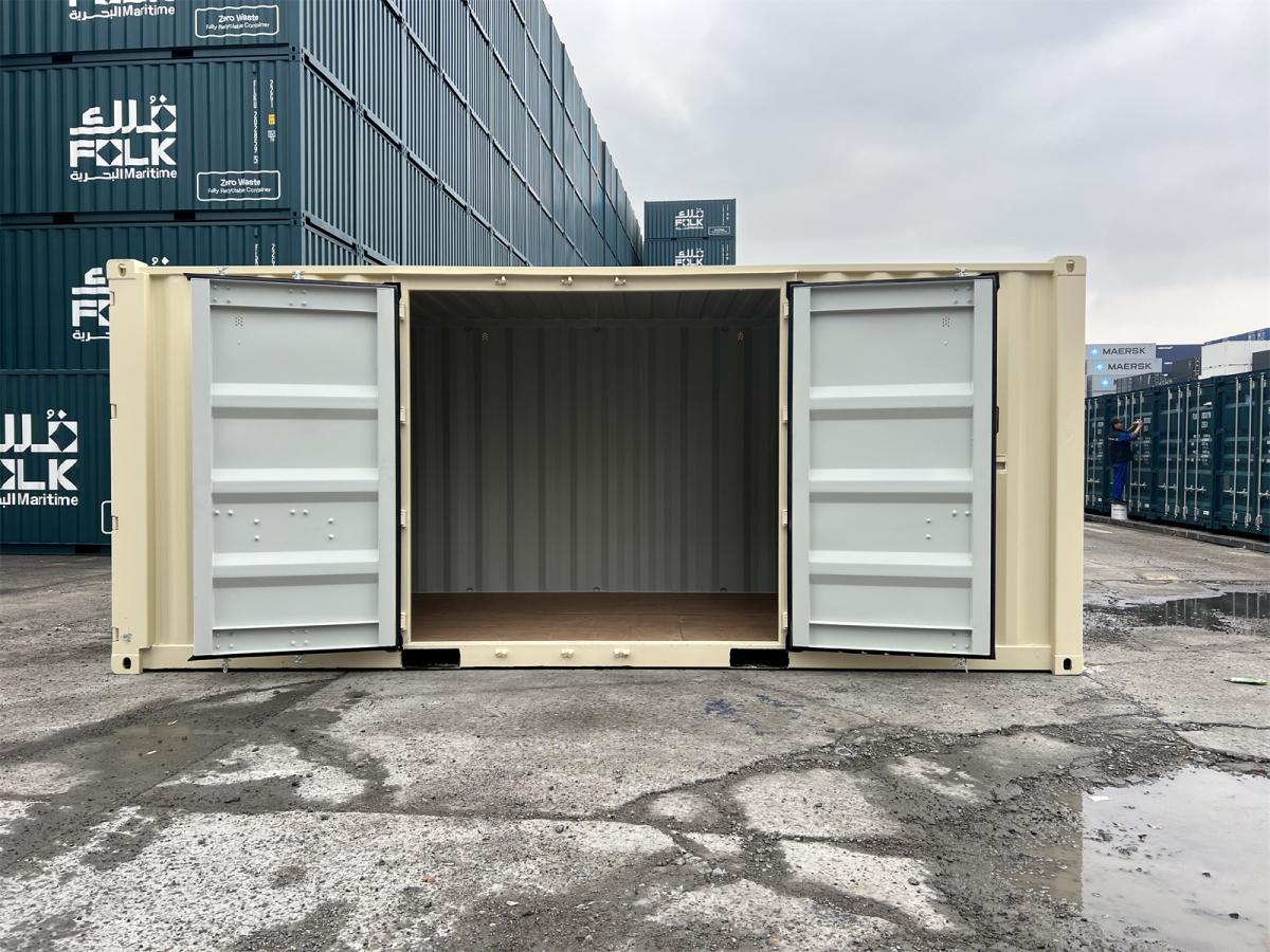 A wide side view of the ivory shipping container with its side double doors fully swung open, revealing the empty interior. The inside walls are light gray corrugated steel, and the floor is made of smooth, warm-toned plywood.