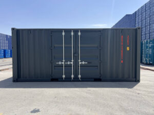 A direct, wide side view of the dark gray shipping container showing the closed side double doors. The container code "BETU 330051 4" and a height warning label are printed vertically in orange on the right side of the panel.